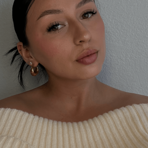 Woman in off-the-shoulder sweater.