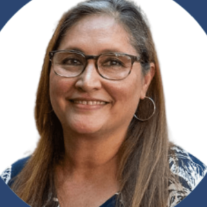 Headshot of woman wearing glasses and earrings.